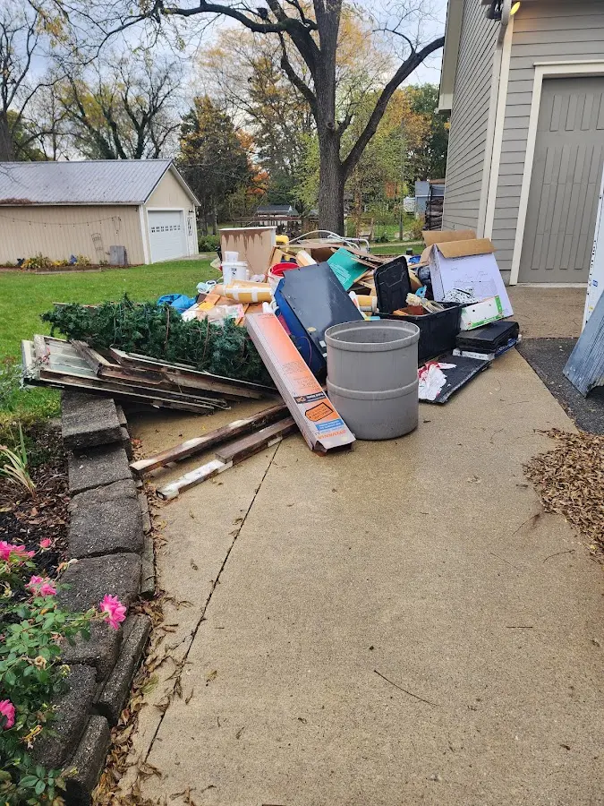 Dumpster being loaded with debris for 12 Yard Dumpster Rental in Jefferson City